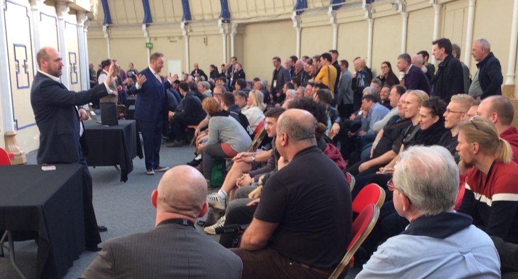 Paul Roberts Magician & Hypnotherapist from Wrexham speaking confidently in front of a large room of other performers some of whom may have stage fright